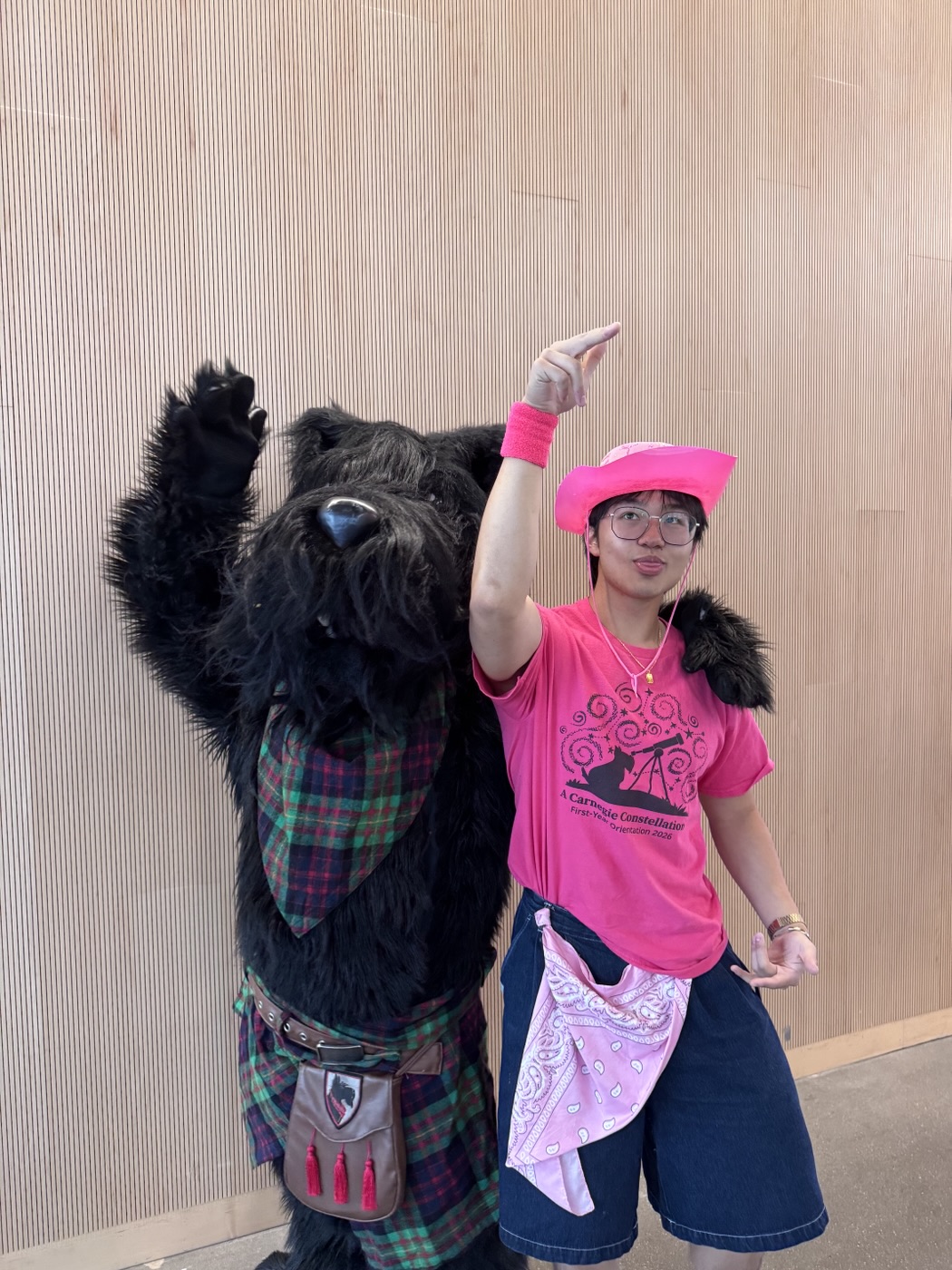 Jin in a pink cowboy hat posing with the Scotty dog mascot